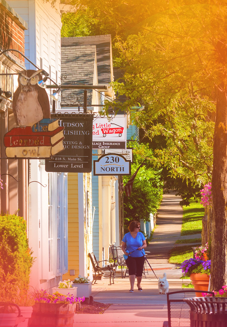 woman walks along the sidewalk in historic roswell