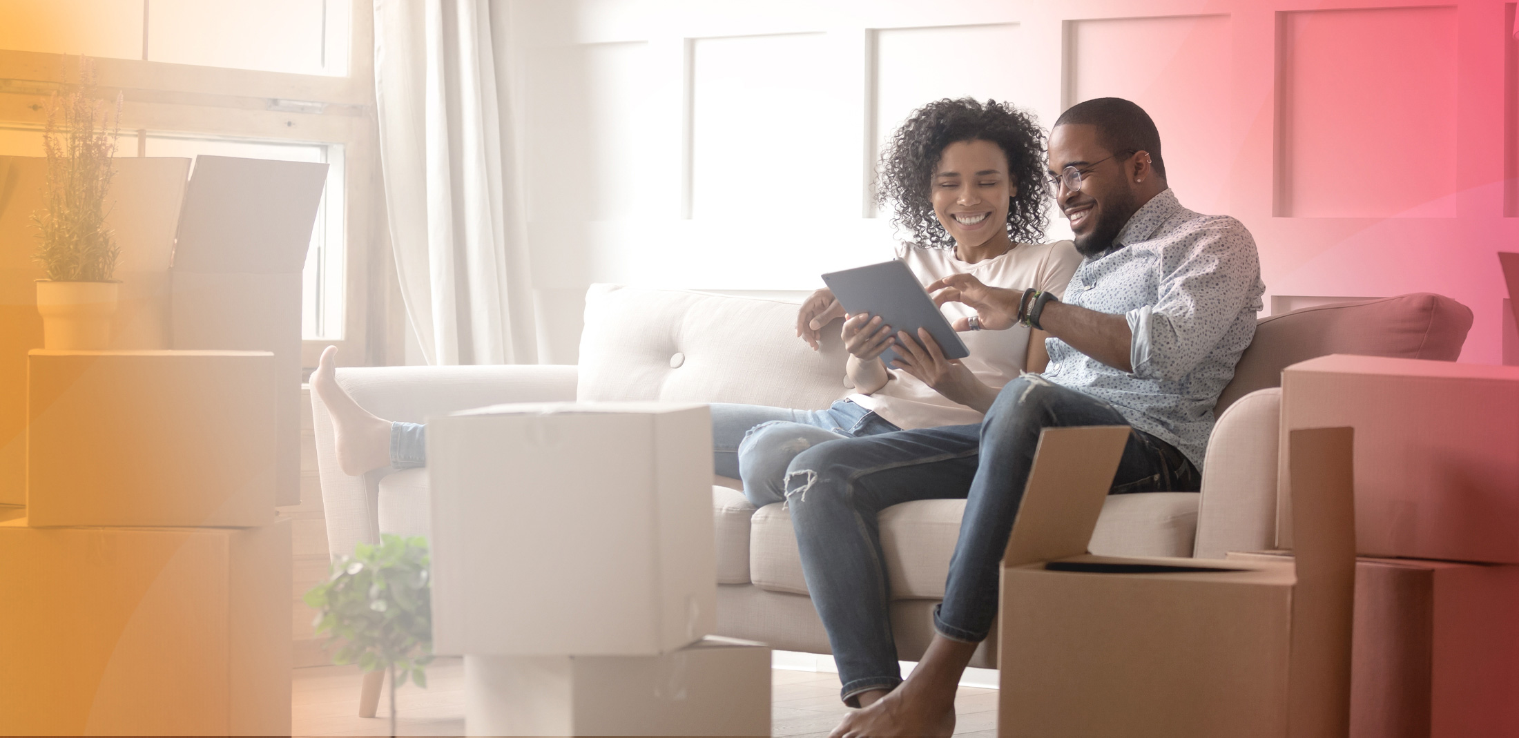 Couple on couch with moving boxes