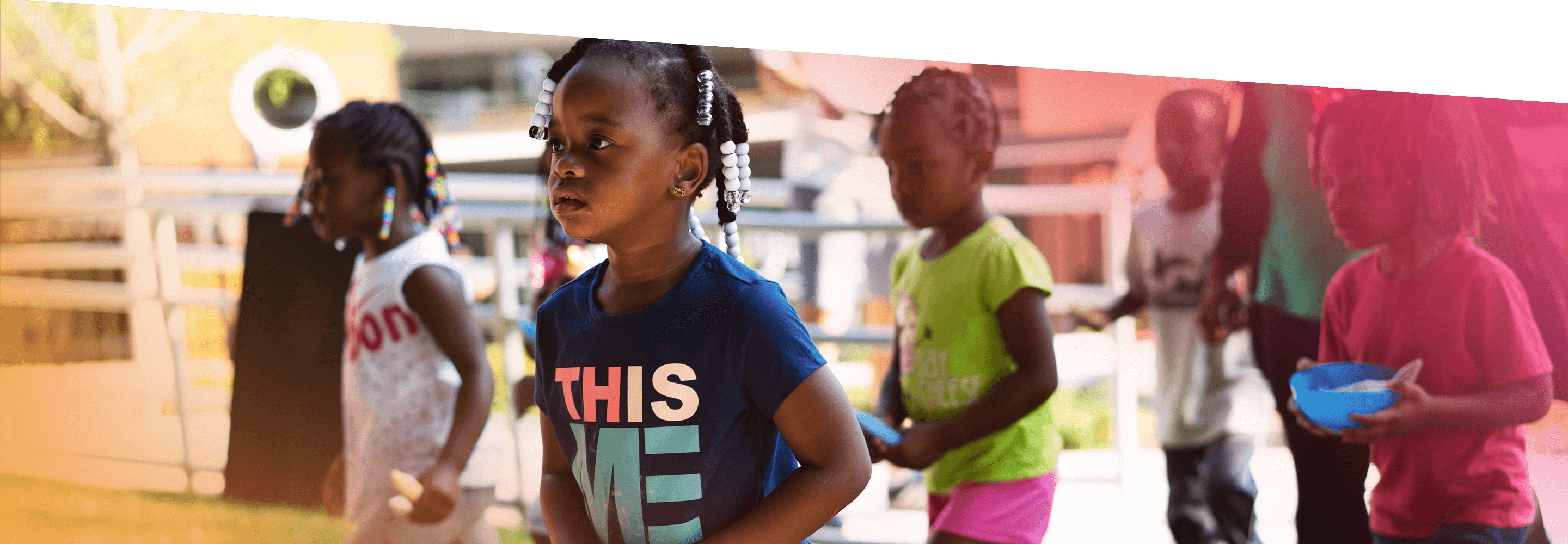 3 young girls play outdoors with chalk at the YMCA